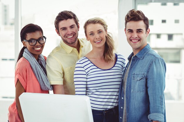 Creative business team working hard together on pc in casual office