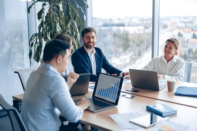 Creative business team working on project in modern office with panoramic view