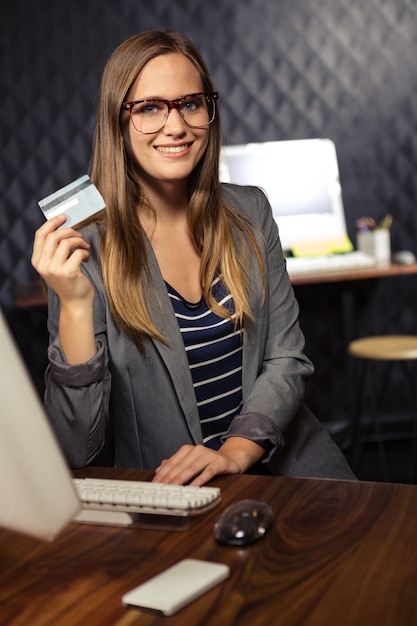 creative businesswoman showing a credit card