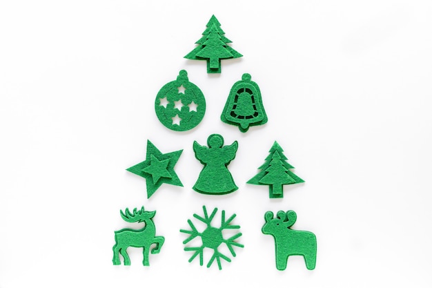 Photo creative christmas tree layout made from felt decorations. flat lay, top view. holiday festive minimal concept