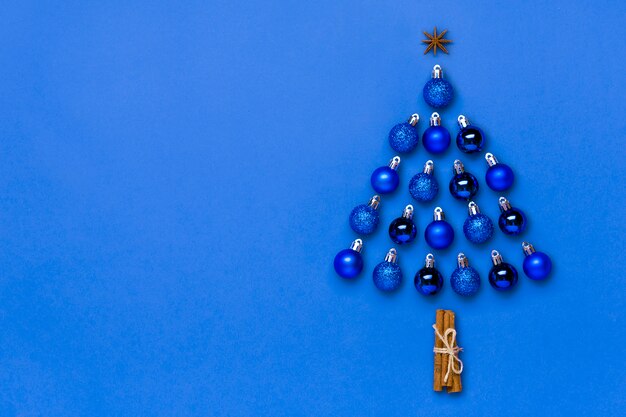 Creative Christmas tree made of blue bauble and star decoration isolated on color of the year 2020