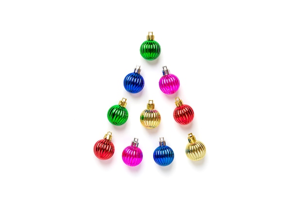 Photo creative christmas tree made of colorful bauble and golden star decoration isolated on white background.