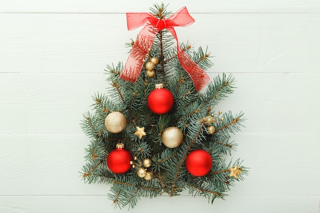 Creative christmas tree on white background with festive decorations balls, new year. Flat lay