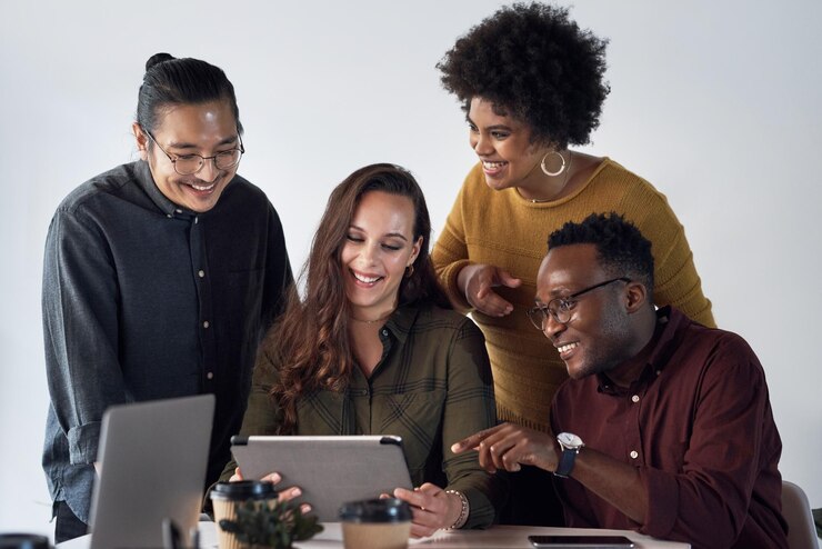 Photo creative collaboration and business people with tablet ideas and advice for planning in web design teamwork men and women at desk for online brainstorming software development or office project