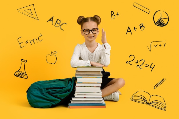 Creative collage with cute little schoolgirl raising hand and drawn educational icons