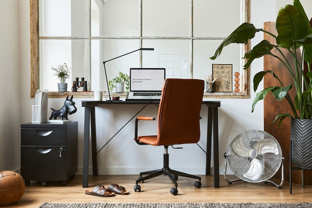 Photo creative composition of modern masculine home office workspace interior design with black industrial desk, brown leather armchair, laptop and stylish personal accessories. template.