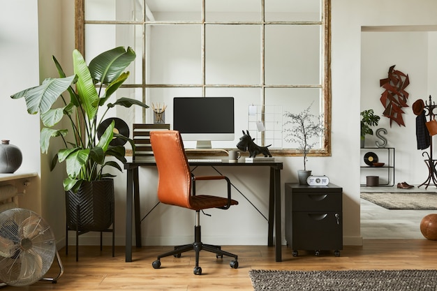 Creative composition of modern masculine home office workspace interior with black industrial desk, brown leather armchair, pc and stylish personal accessories. Template.