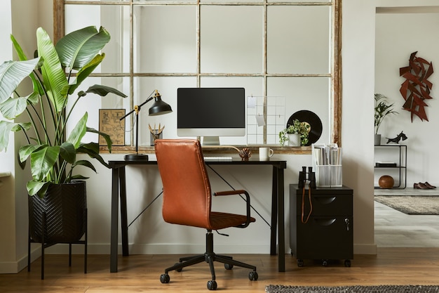 Creative composition of modern masculine home office workspace\
interior with black industrial desk, brown leather armchair, pc and\
stylish personal accessories. template.