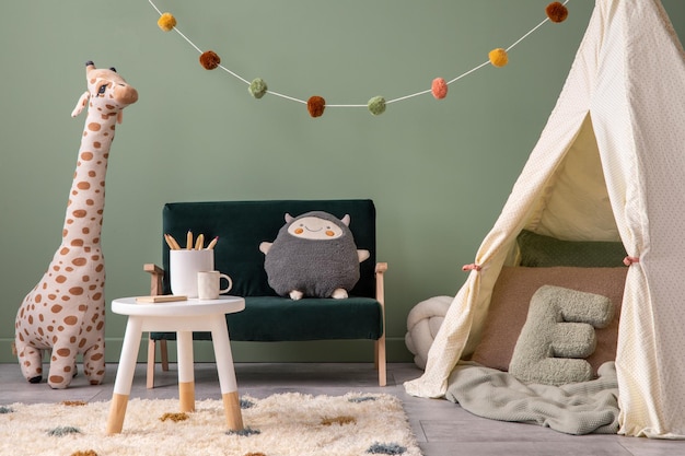 Creative composition of stylish and cozy child room interior design with greeen wall plush toys hut bottle green sofa furniture and accessories Panels floor Copy space TemplatexD