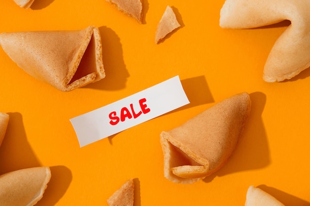 Creative composition with fortune cookies and paper with text on orange background