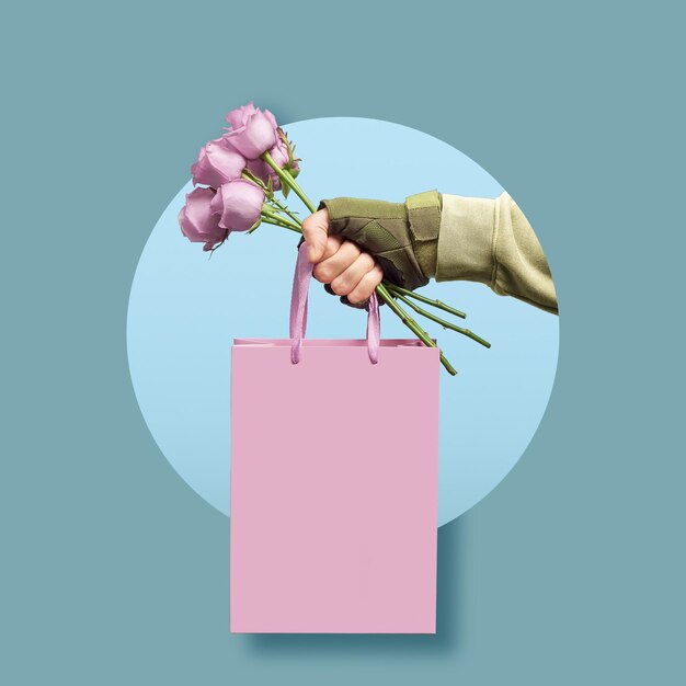 Creative concept for a men's greeting. A man's military hand holds roses with a gift bag.