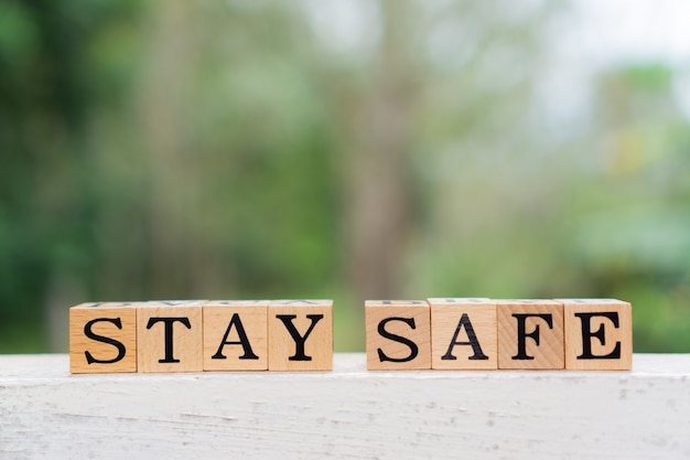 Creative concept Stay Safe text on wooden block.