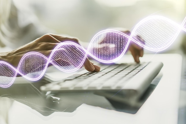 写真 dna シンボルのイラストと背景にラップトップで手を入力する創造的なコンセプト ゲノム研究コンセプト 多重露光