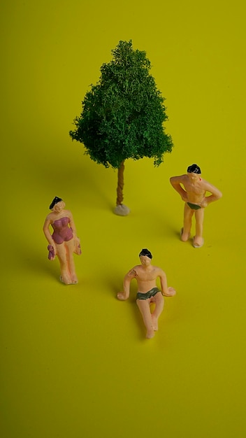 creative concept with miniature people people sit wearing swimsuit