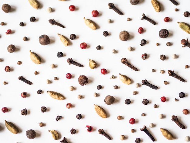 Creative decorative food composition of various spices on white background.