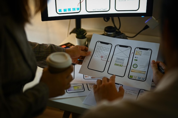 Creative designer team working with template layout framework for mobile phone application