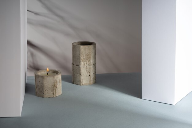 Creative diagonal isometric projection composition with scented\
candles of soy wax in a concrete