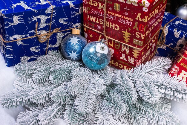 Creative diy craft hobby Making handmade craft christmas ornaments and balls with felt spruce tree christmas tree with colorful balls and gift boxes over white brick wall with blue and white balls