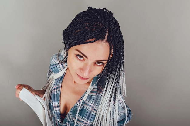 Photo creative dreadlocks hairstyle portrait of graceful woman with white afro braids in checkered shirt