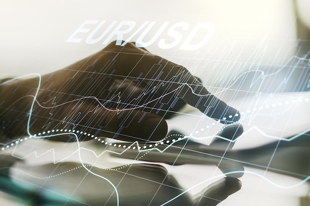 Creative EURO USD forex graph sketch and hand working with a digital tablet on background strategy and forecast concept Multiexposure