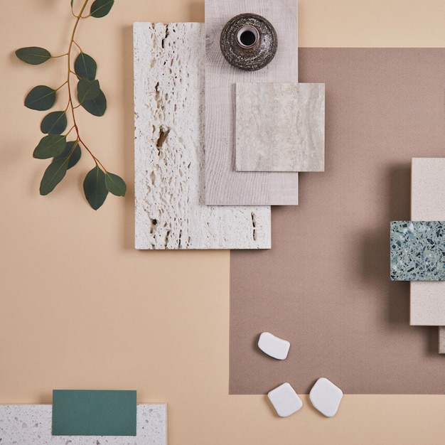 Creative flat lay composition of interior designer moodboard with textile and paint samples panels and cement tiles Beige grey and green color palette Copy space Template