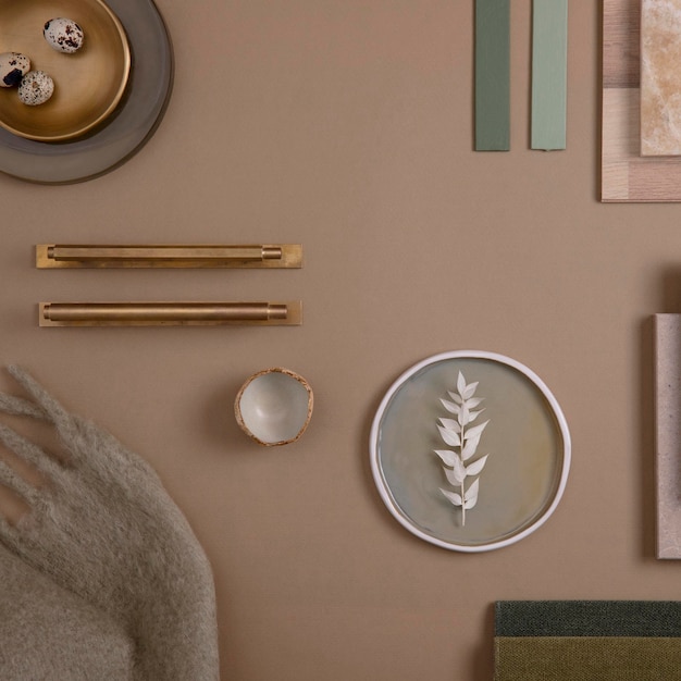 Creative flat lay composition of interior designer moodboard with textile and paint samples panels and tiles Beige brown and green color palette Copy space Template