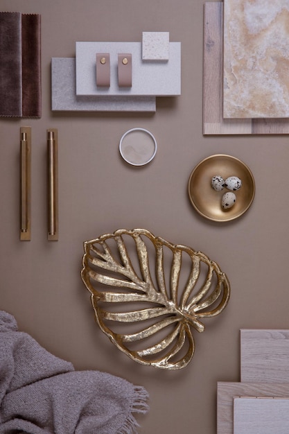 Creative flat lay composition with textile and paint samples panels and tiles Stylish interior designer moodboard Golden and dark beige color palette Copy space Template