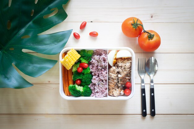 Creative flat lay of lunch box with variation colour of vegetables 