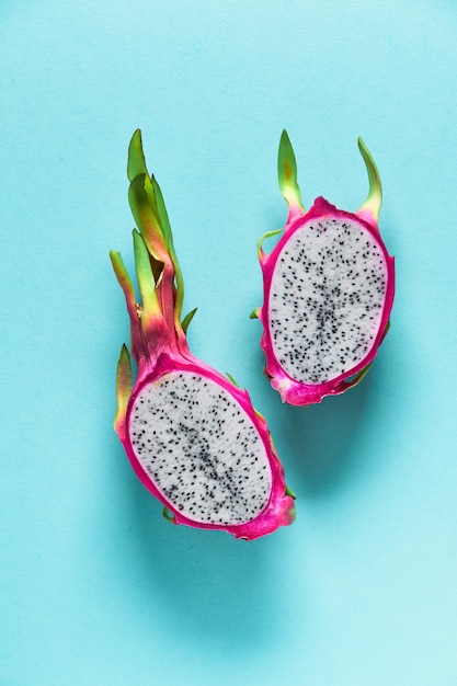 Photo creative flat layout with fresh organic pink dragonfruit on blue