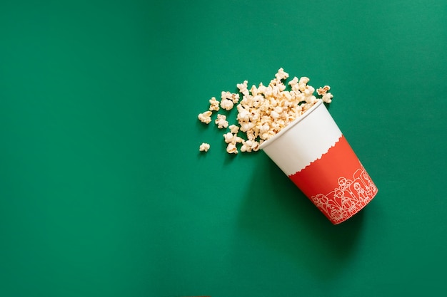 Creative food composition of popcorn in paper bag. Unhealthy diet concept.