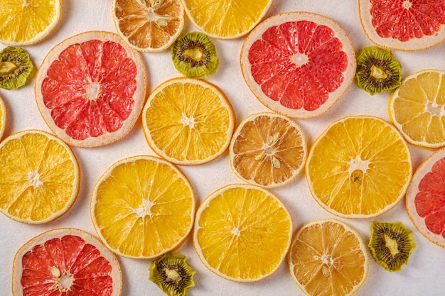 Creative food fruit texture with dried grapefruit, orange, kiwi and lemon on white, top view