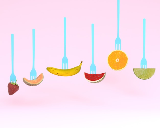 Photo creative of fruits on the collection of forks on pink background