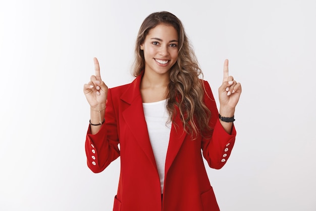 Creative gorgeous businesswoman making presentation pointing up index fingers smiling broadly looking self-assured discussing business income profit, assure client make investment