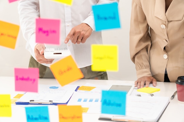 Creative group of business people brainstorming using sticky notes