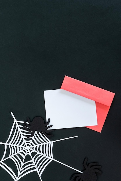 Creative halloween composition card pink envelope spider spider web on black background with place