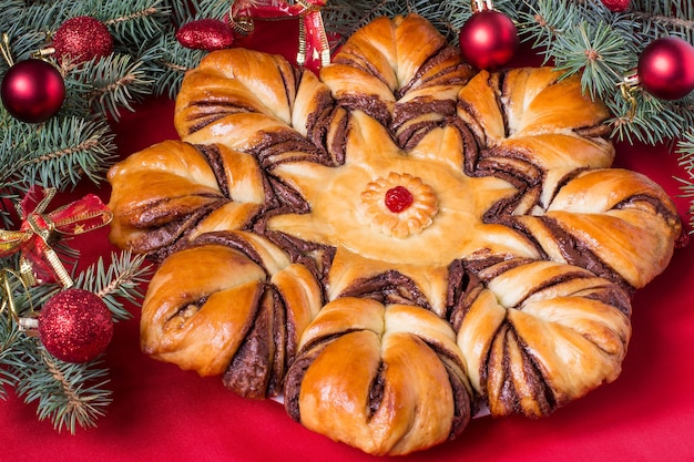 Creative homemade cake of yeast dough filled with chocolatefor Christmas party