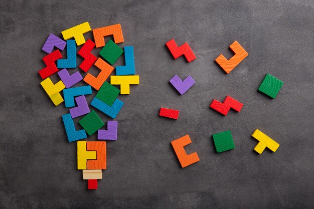 Creative idea and solve the problem concept Teamwork success strategy wooden jigsaw on the grey background