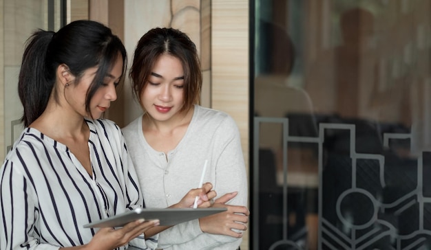 Creative idea teamwork concept group of asian woman using digital tablet and pen stylus drawing at