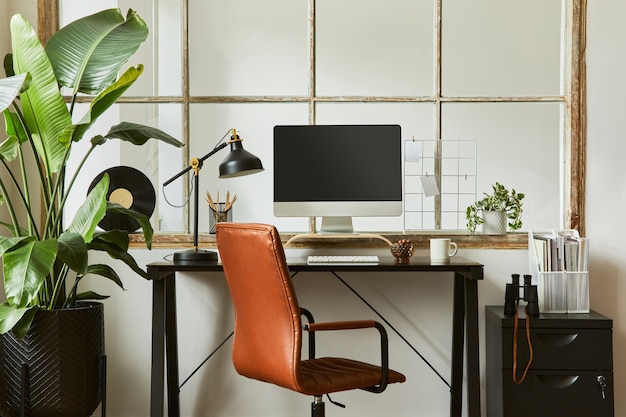 Креативная композиция интерьера современного мужского домашнего офиса с черным промышленным столом, коричневым кожаным креслом, компьютером и стильными личными аксессуарами. Шаблон.