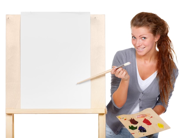 The creative juices are about to flow studio shot of a young woman holding a palette and brush and s