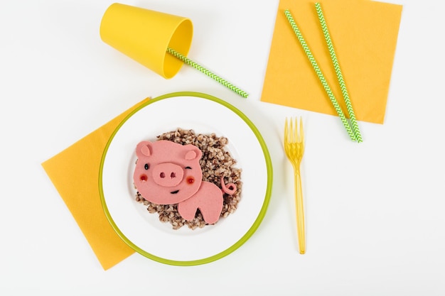 Creative kids food Omeletbreadketchupvegetables on the white background