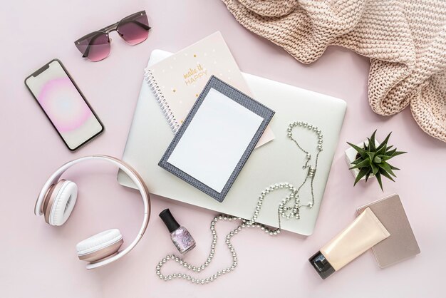 Photo creative lady stile desk workspace with computer phone cosmetics glasses on pink background