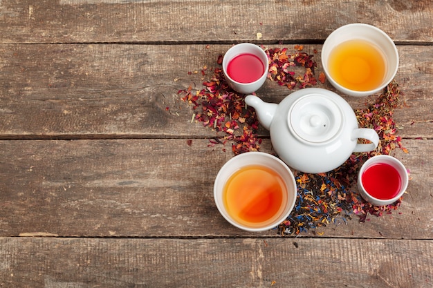 Creative layout made of cup of herbal tea on a wooden background