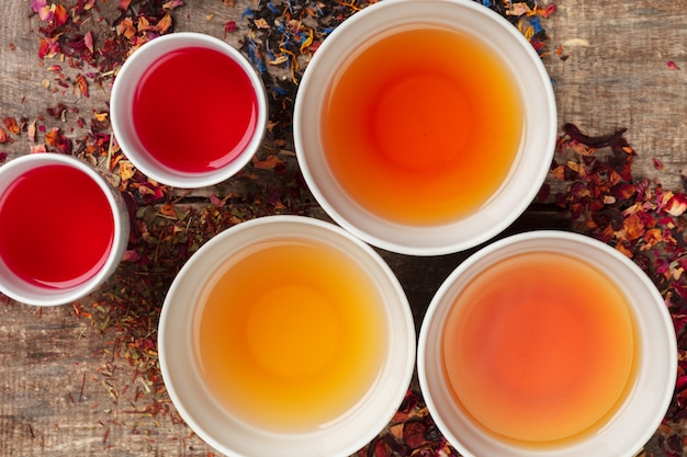 Creative layout made of cup of herbal tea on a wooden background