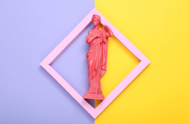 Creative layout Pink Antique greek goddess statue in frame on purple yellow background Minimalism Flat lay Top view