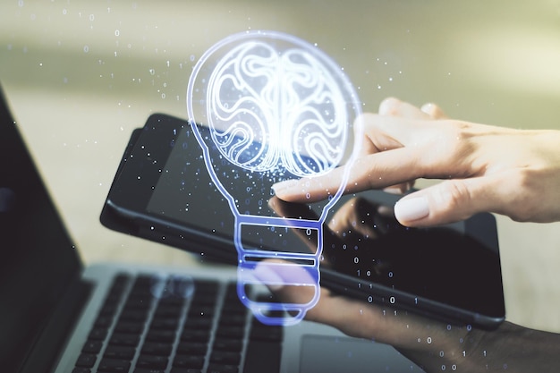 Creative light bulb illustration with human brain and with\
finger presses on a digital tablet on background future technology\
concept multiexposure