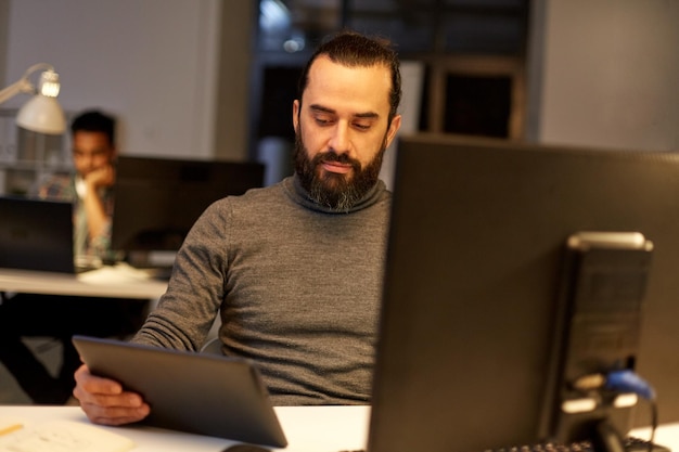 creative man with computer working late at office