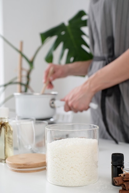 Foto occupazione creativa di fabbricazione di candele donna che produce candele con cera di soia che lavora in