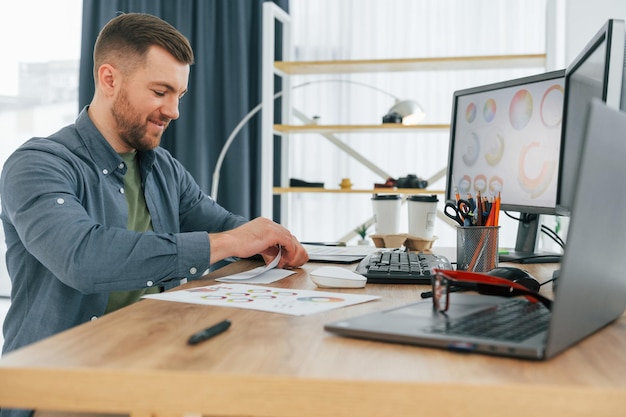 Creative occupation male designer working in the office by
using pc