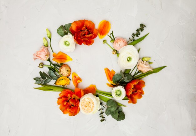 Creative orange and beige flowers flat lay frame for design